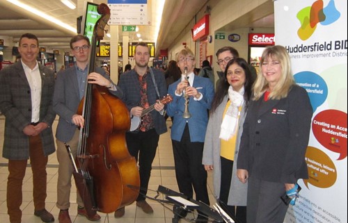 L-R Huddersfield Bid manager Matthew Chapman, The Jelly Roll Jazz Band, Cllr Councillor James Homewood (West Yorkshire Combined Authority Transport Committee and Kirklees Council) Cllr Manisha Kaushik, (Deputy Chair of West Yorkshire Combined Authority Transport Committee and Kirklees Council) and Helend Schofiled, Huddersfield Bus Station Manager